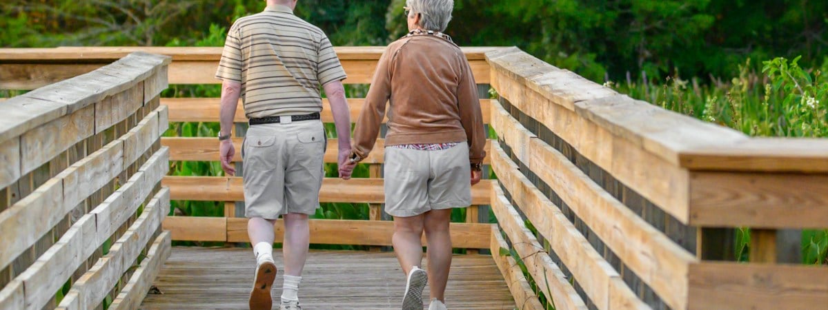 A mature couple smiling together outdoors